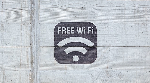 A black Wi-Fi symbol on a wooden wall.